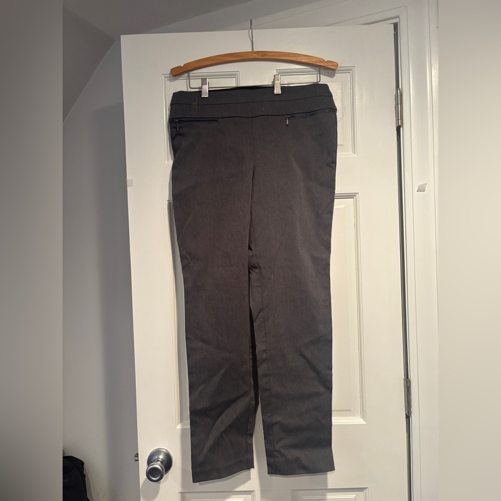 Grey slacks 2 fake zipper pockets in the front and 2 fake pockets in the back
